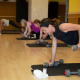 Woman in plank position in a group fitness class