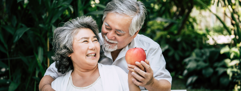 Older couple sitting outside on a bench