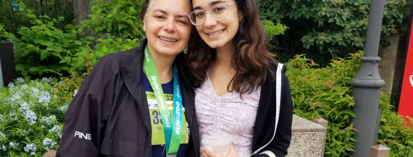 FFC Member Renu Kulkarni standing outside with her daughter.