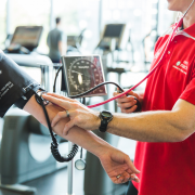 man checking women's heart rate