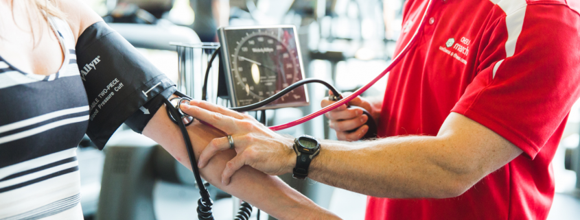 man checking women's heart rate