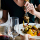 Close up of a woman eating a meal.