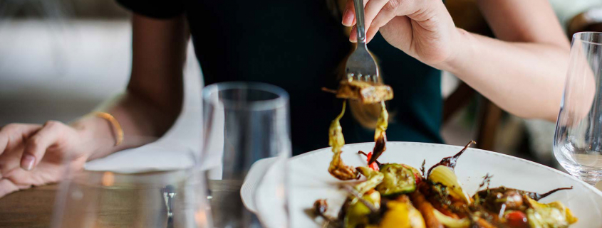 Close up of a woman eating a meal.