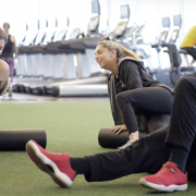 Friends laughing together in a gym.