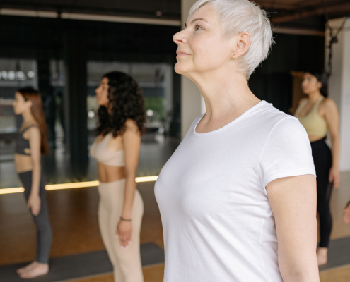 Woman standing in Mountain Pose in Yoga Class
