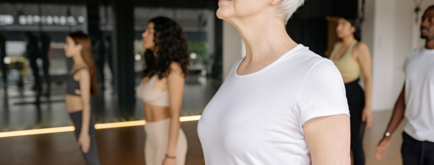 Woman standing in Mountain Pose in Yoga Class