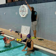 Grit Endurance Coach Jim instructing swimmers at the pool