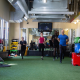 Image of 4 people running on indoor turf in a gym