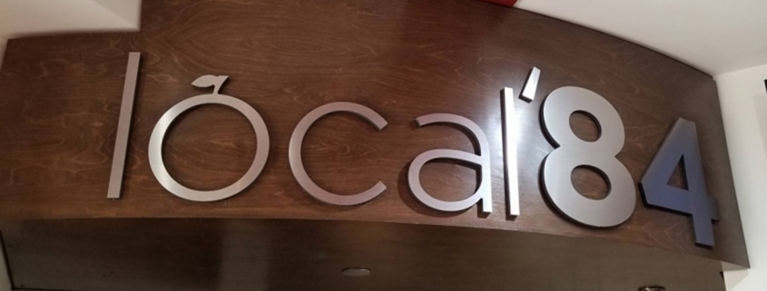 Image of local'84 cafe logo in a cafe