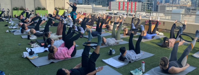 A group of members taking an outdoor class at the FFC Lincoln Park turf