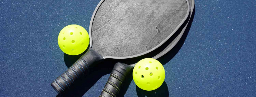 a picture of pickleball rackets on a pickleball court