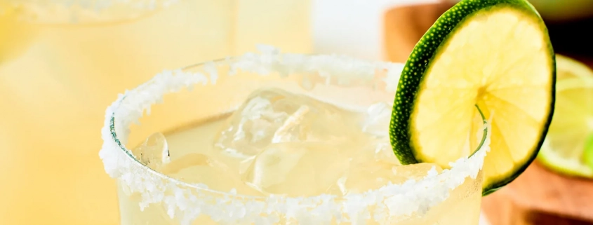 A margarita with a lime and salt on the rim