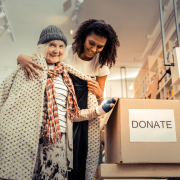 A women donating here coat during a coat drive