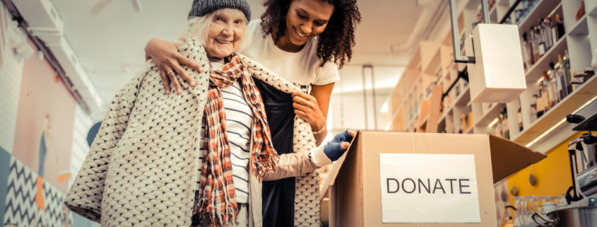 A women donating here coat during a coat drive