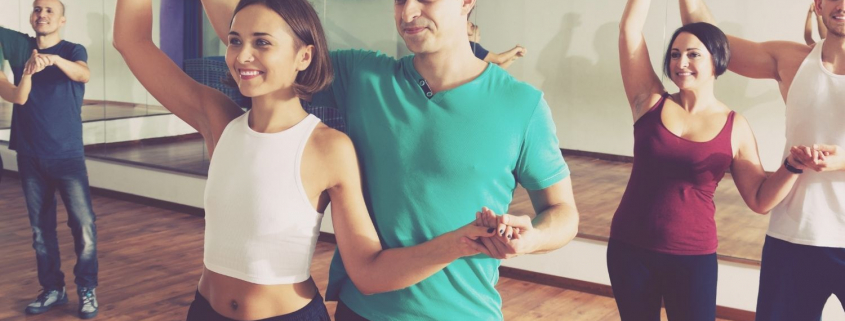 Couples learning how to salsa dance