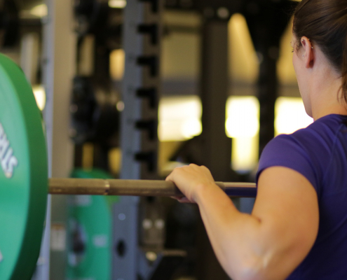 Close up woman on barbell