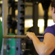 Close up woman on barbell
