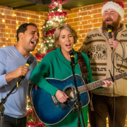 A group of people singing Christmas sing-alongs