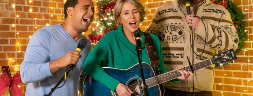 A group of people singing Christmas sing-alongs