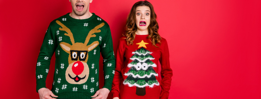 Two people wearing ugly Christmas sweaters