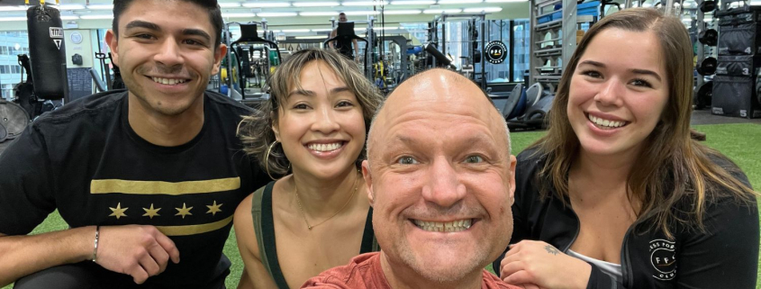 four members taking a selfie on the turf