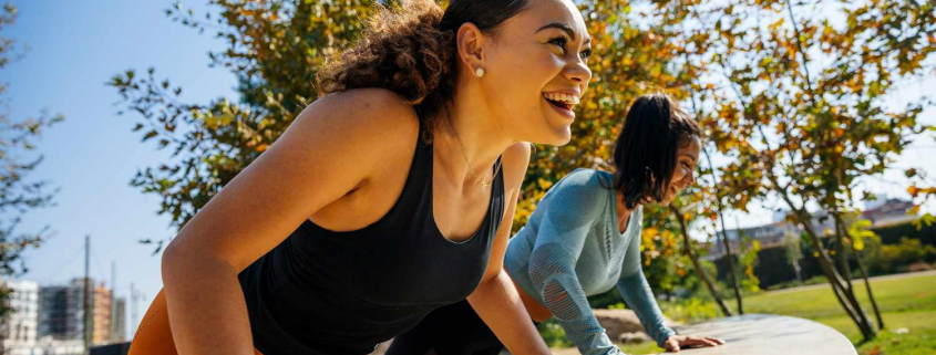 Two women participating in an outdoor workout
