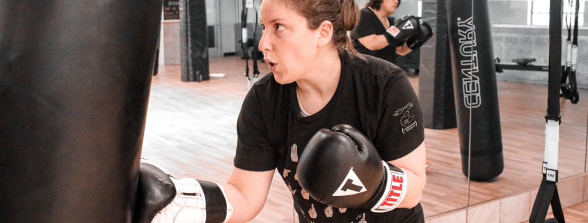 Woman punching a punching bag at Chicago's best gym