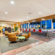 Club Lounge with full-service bar, fireplace and seating area inside Elmhurst Gym.
