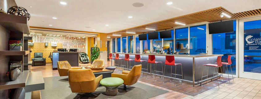 Club Lounge with full-service bar, fireplace and seating area inside Elmhurst Gym.