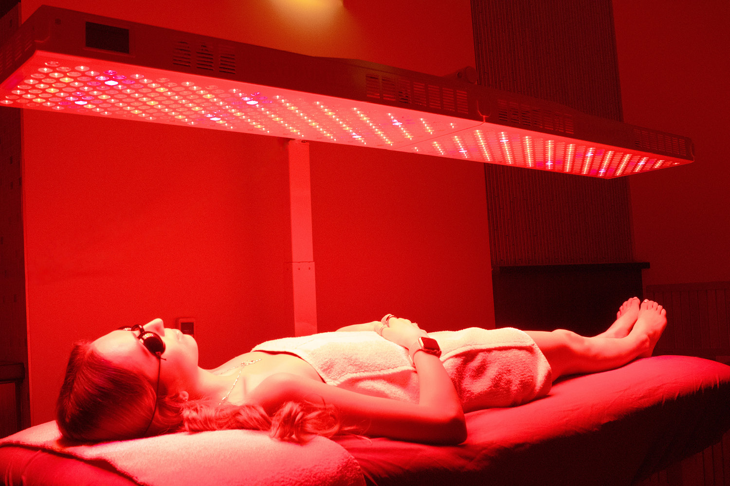 Member relaxing on the Red Light Therapy bed at FFC West Loop.jpg