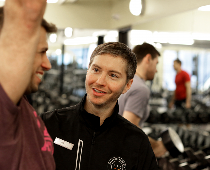 Personal Trainer helping his client with his upper body form FFC Union Station.jpg