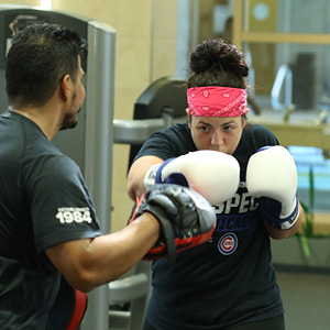 personal trainer instructing boxing client