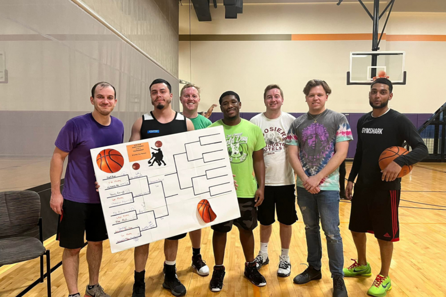 Group of FFC Union Station Members playing basketball with their scorecard for tournaments.