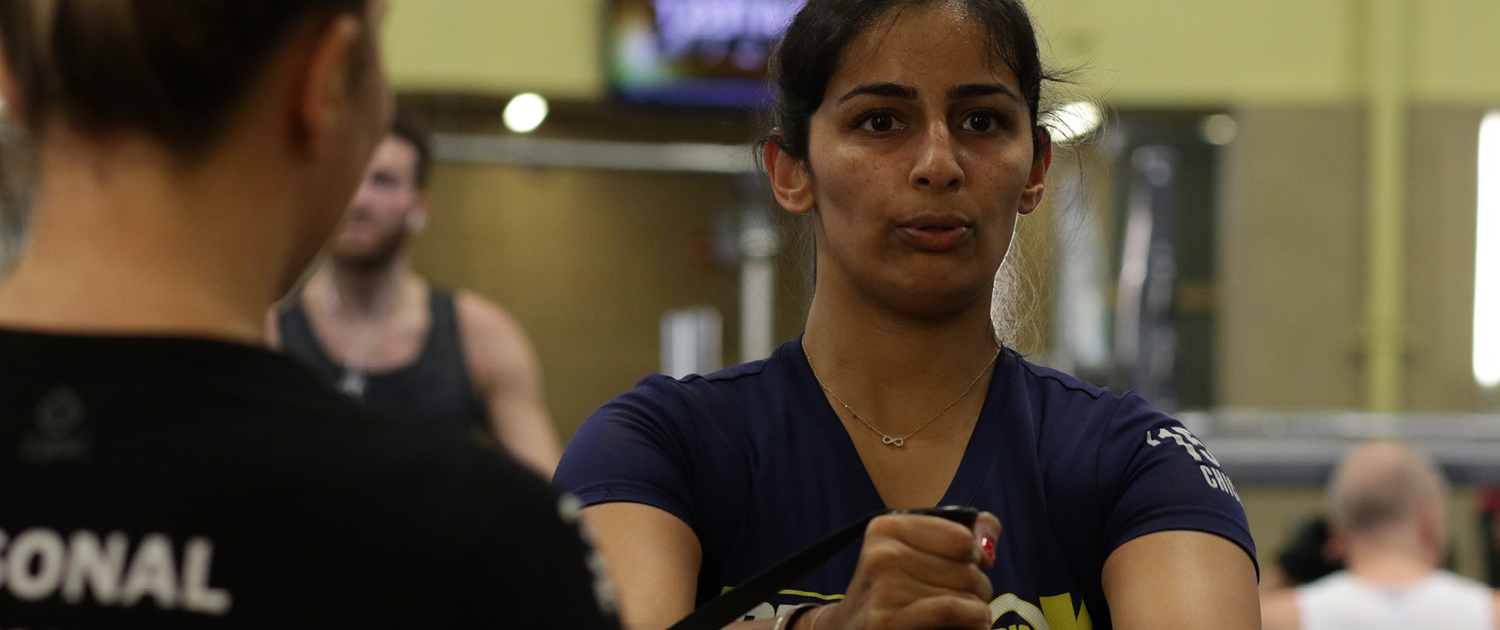 Personal Trainer assisting client at FFC West Loop